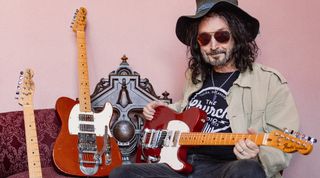 Mike Campbell poses with his Red Dog Fender Telecaster and a pair of 2025 tribute models Fender created on behalf of the instrument