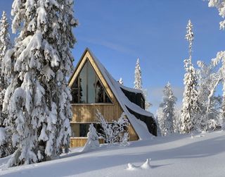 timber cabin in the snow