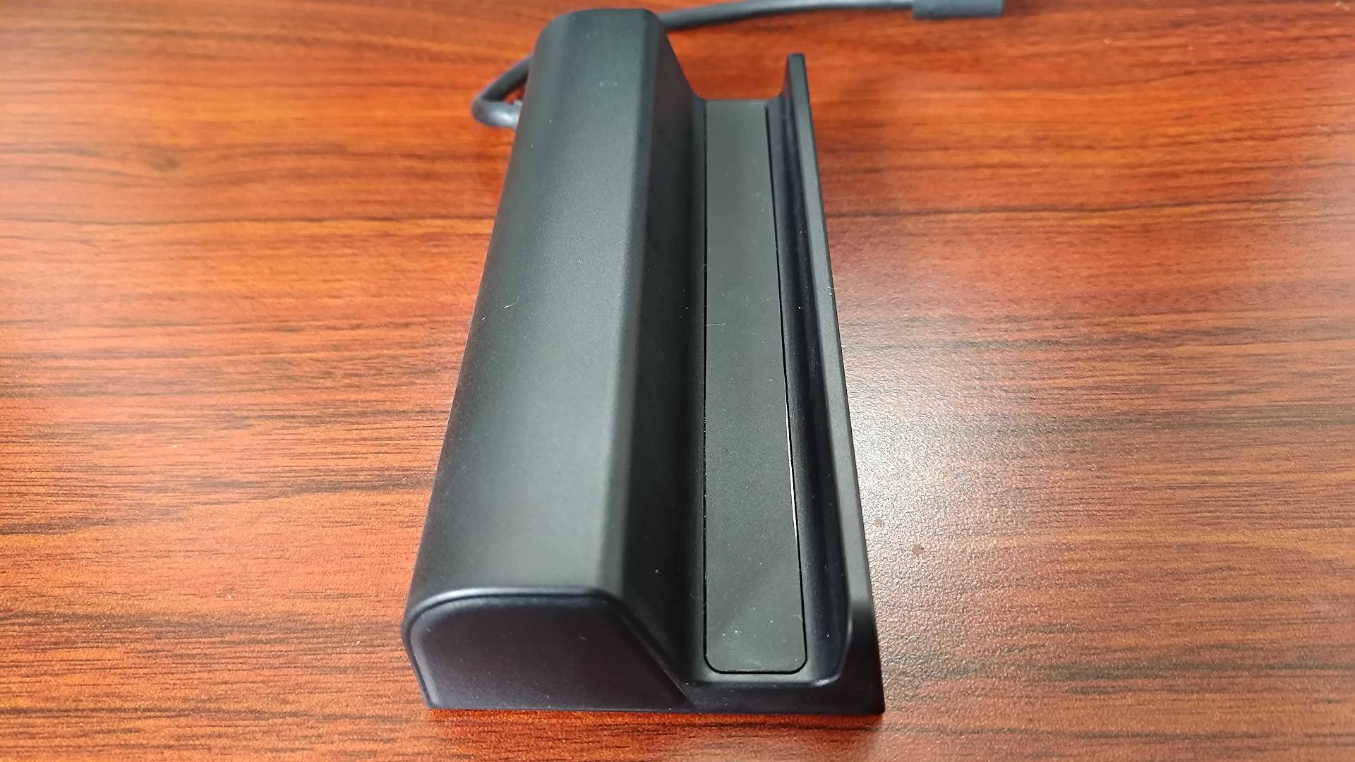Side view of Antank Steam Deck dock on woodgrain desk.