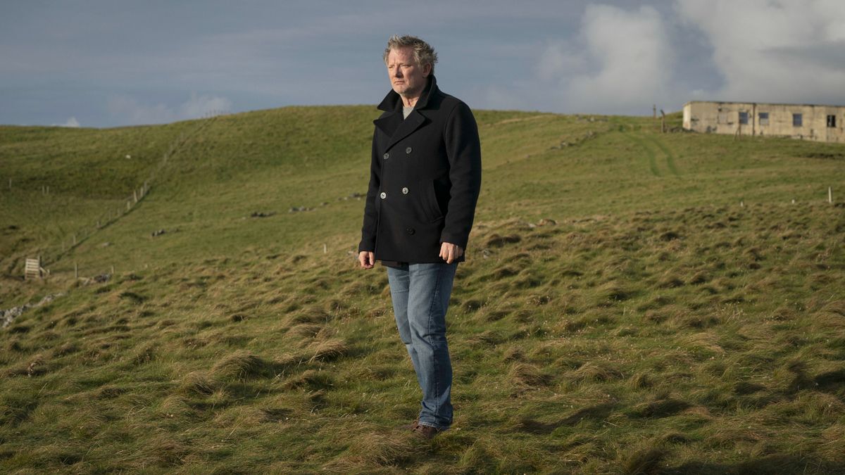 Jimmy Perez (Douglas Henshall) stands in an open field in Shetland season 7