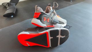 Under Armour HOVR Apex 3 laced up and stacked on a workout mat