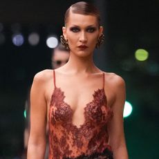 Bella Hadid returned to Saint Laurent's runway in a lingerie-inspired, Fall 2026 lace skirt set 