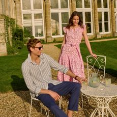 Male and female models wearing Crew Clothing Summer outfits having a drink in the sun