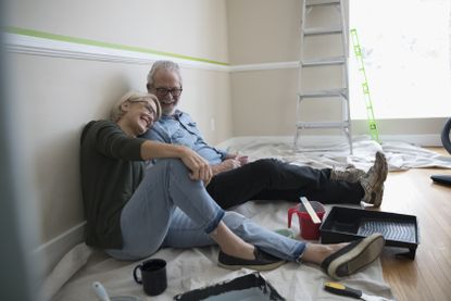 couple sitting in room they are decorating