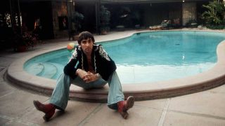 Keith Moon seated by his swimming pool in 1974