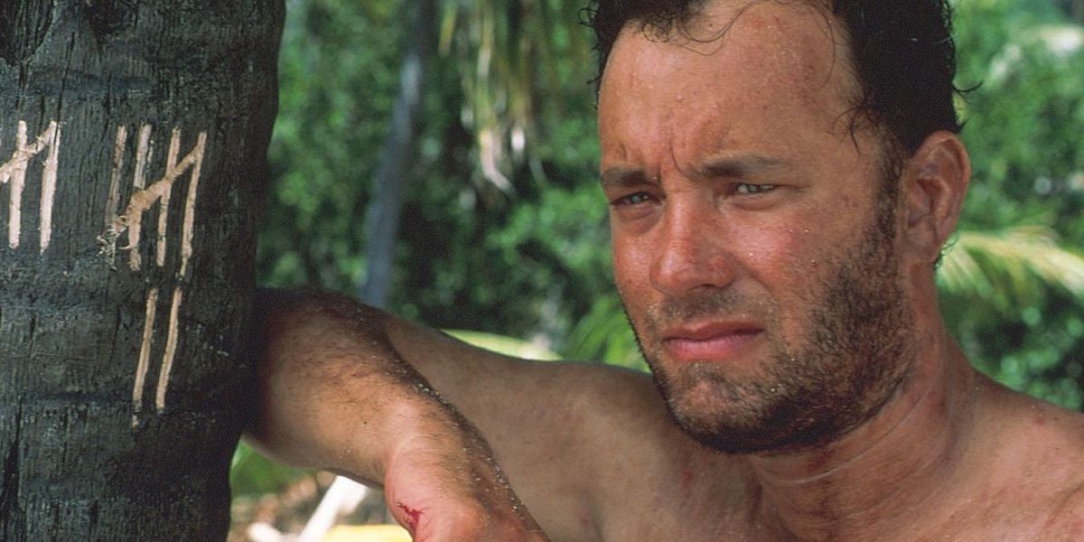 Tom Hanks leaning on a tree with tally marks in Cast Away