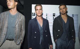 3 male models in dark suit jackets