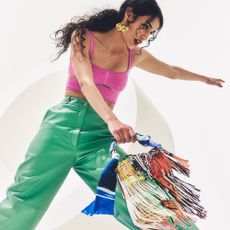 Woman wearing clothes and a bag from The Outnet