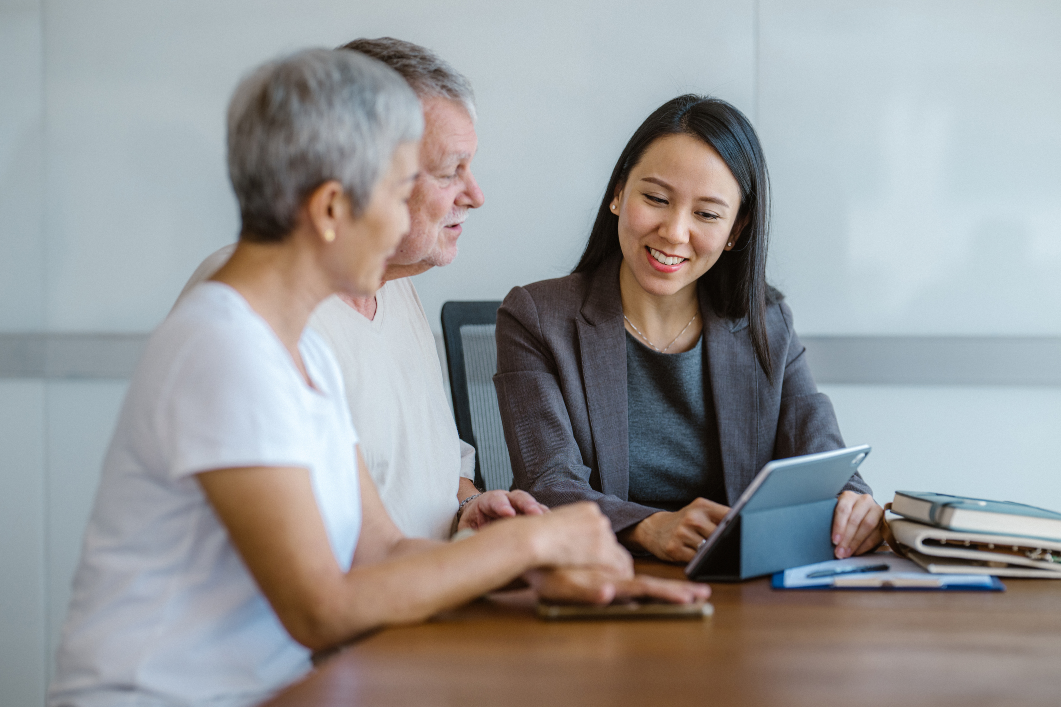 A couple is going over their life insurance policy with their insurance agent. 