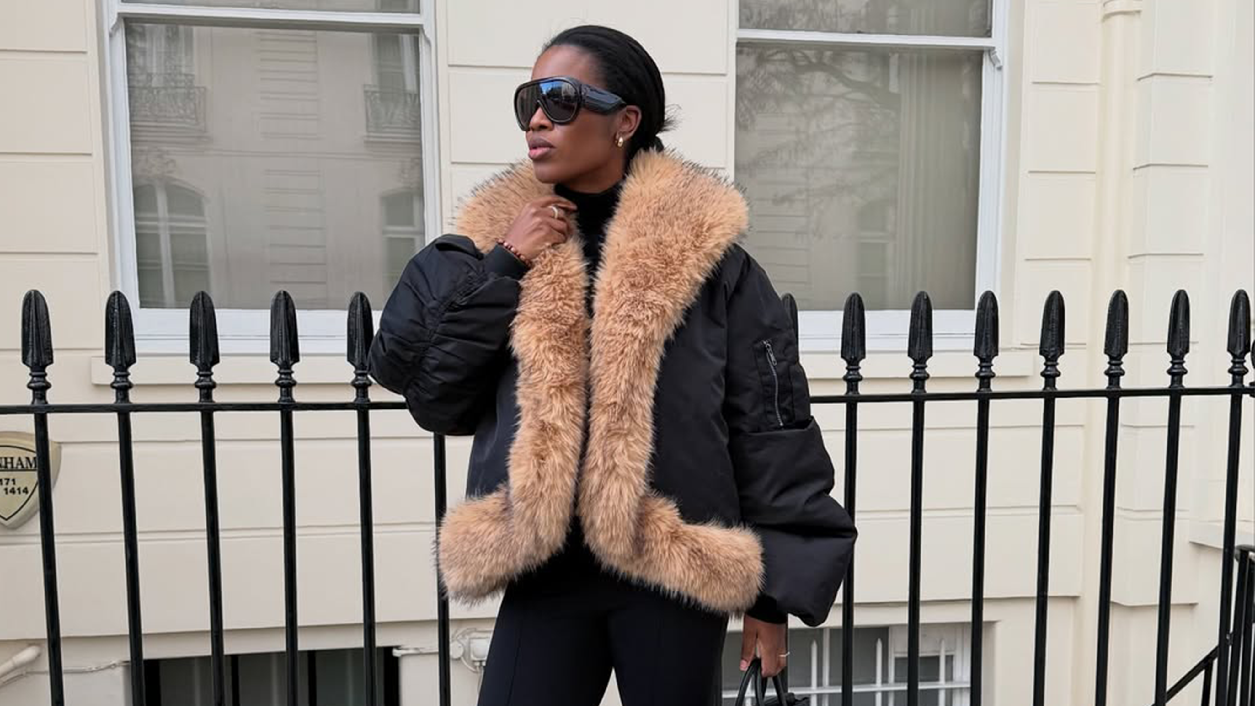 @nlmarilyn wearing a fur-trimmed coat with Tom Ford aviator sunglasses.