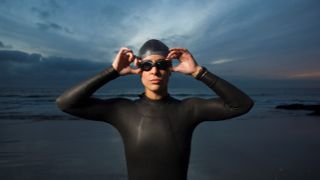 woman in wetsuit on beach