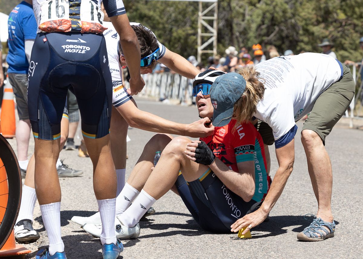 Matteo Dal-Cin (Toronto Hustle) needed help from Sarah Guck, the official Race Chaplin, to get off his bike and onto the ground after leaving everything on the climb into Pinos Altos.