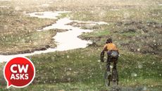 A cyclist riding in the rain