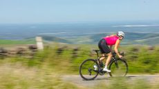 Female cyclist descending at speed