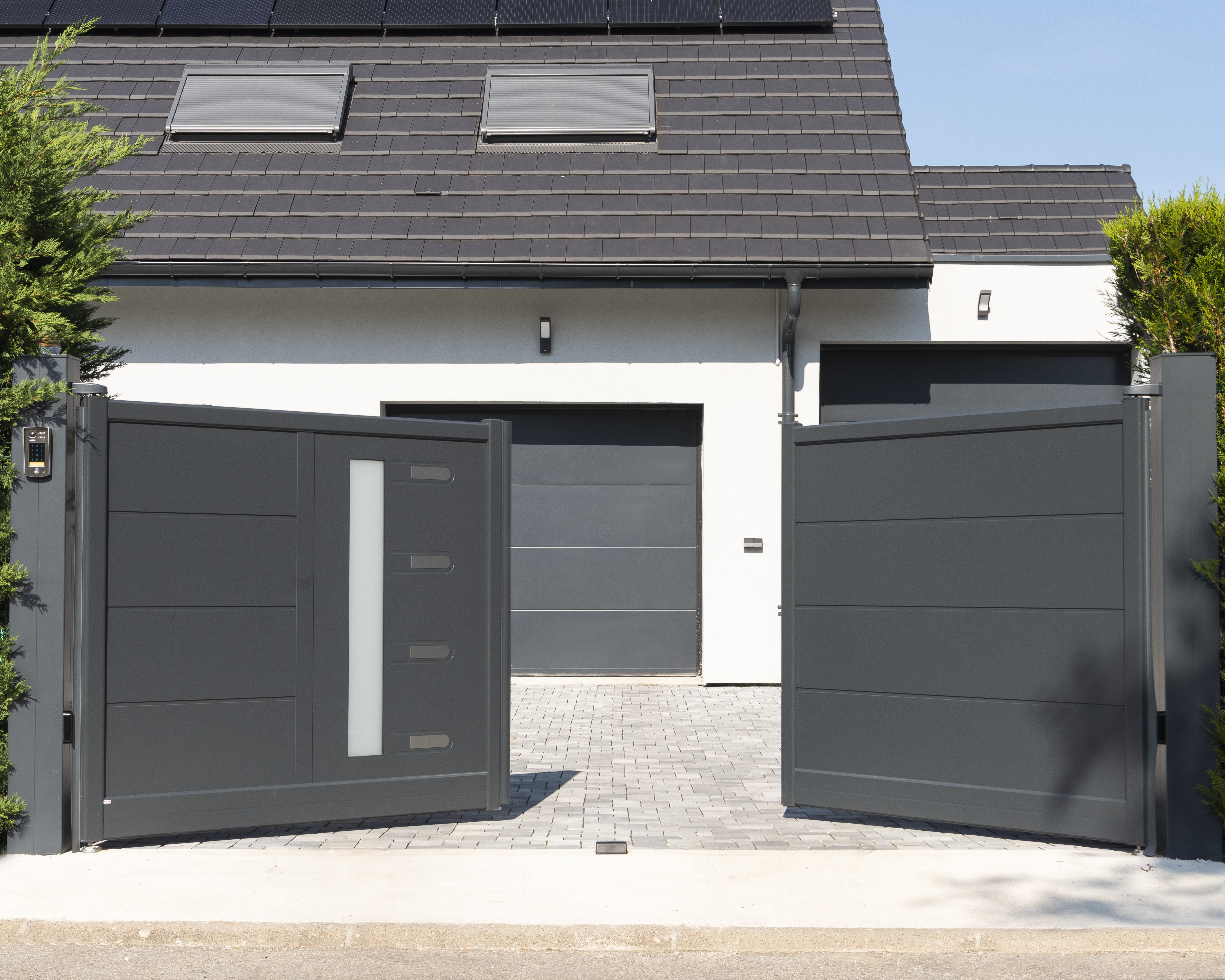 Electronic gates open up to garage doors