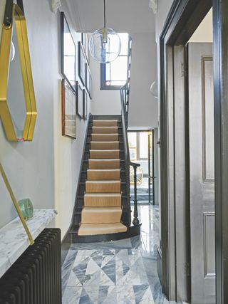 black painted staircase with white walls and gallery