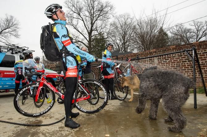 Isaac Howe multi-tasks at the Team SmartStop p/b Mountain Khakis camp with a bit of dog washing.