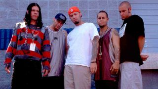 Limp Bizkit posing for a photograph backstage at a festival in 1997