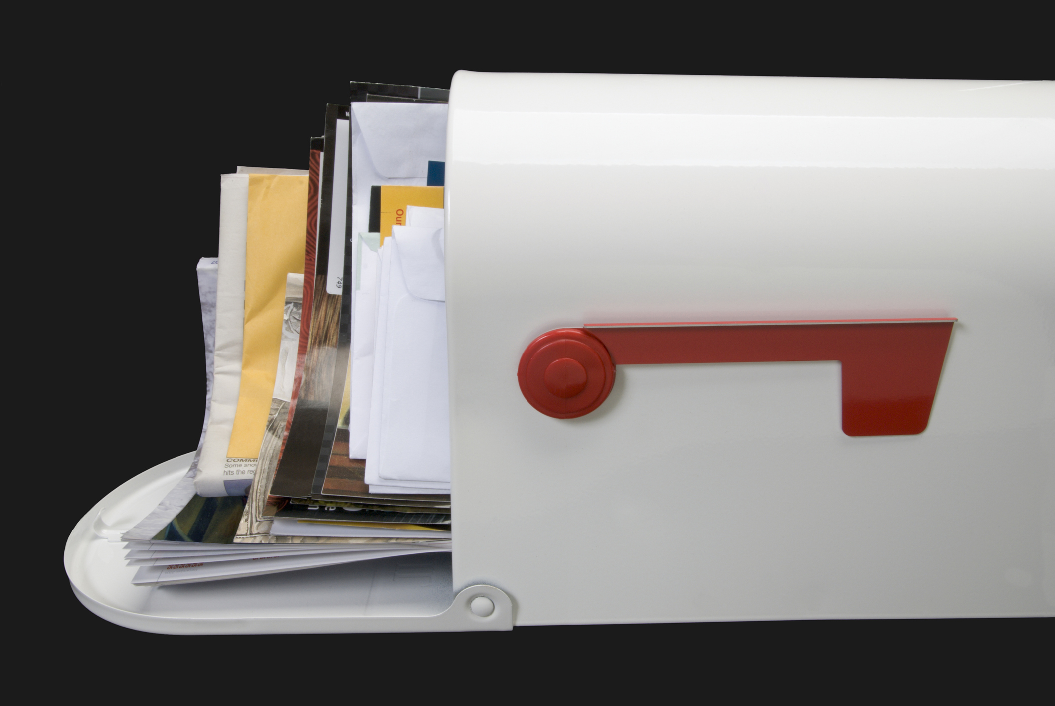 White mailbox full of mail, side profile on black background.