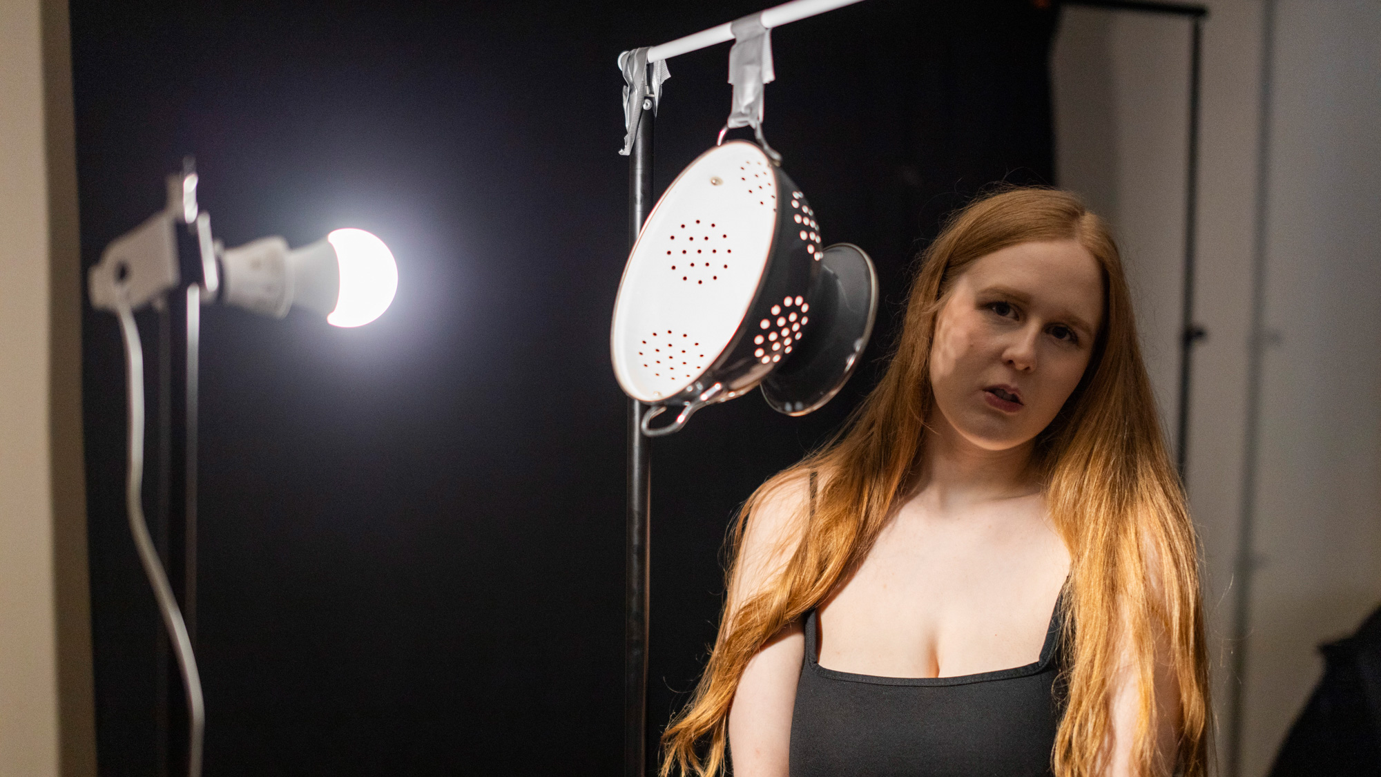 Photographing a female model in a home studio using a single light and a colander