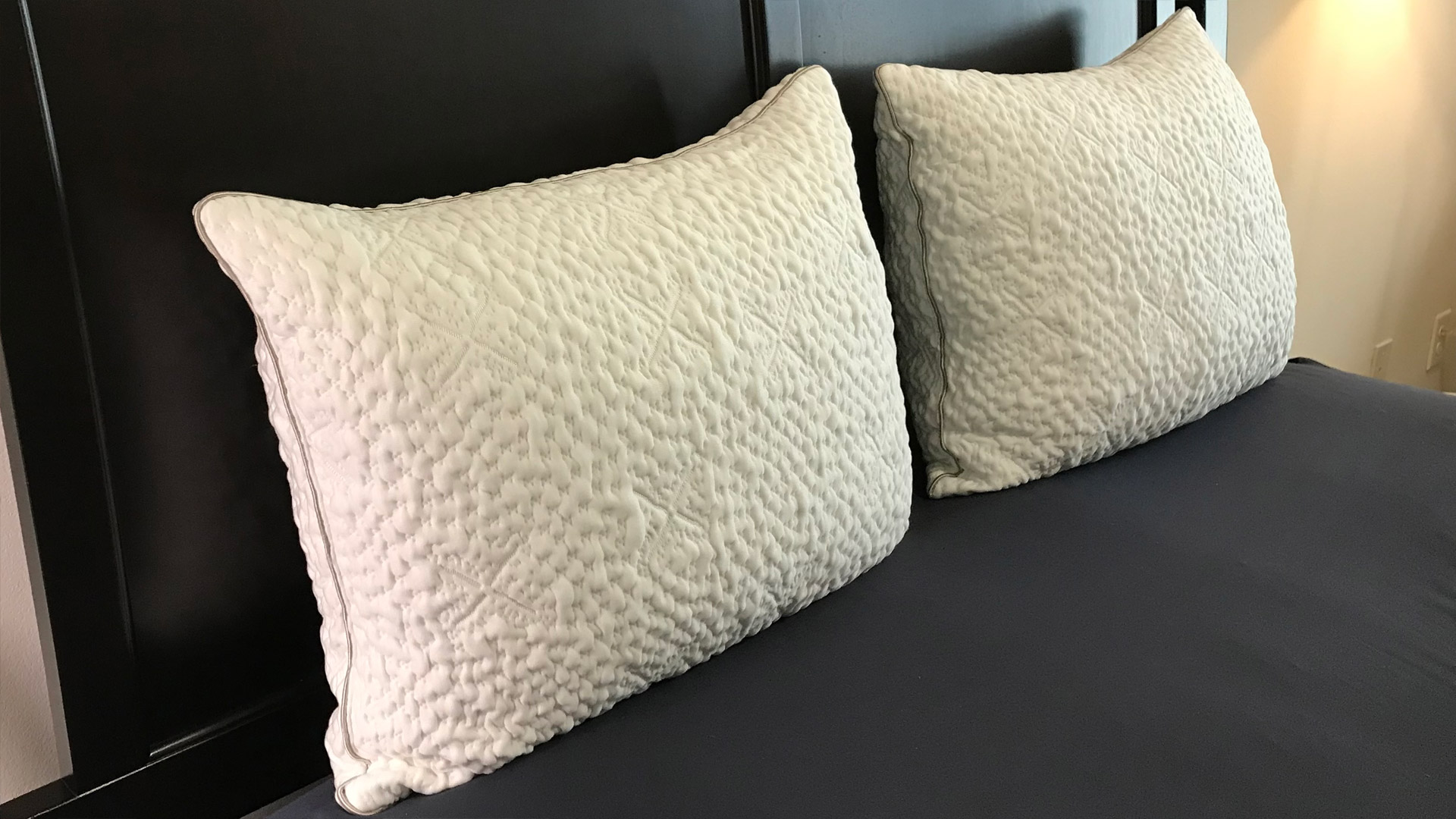 Two Two Sleep Number ComfortFit Pillows side by side on a bed