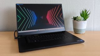 A Razer Blade 17 on a wooden desk, one of the best photo-editing laptops