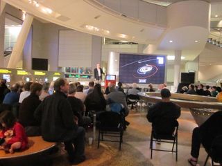 American Museum of Natural History Earth science curator Dentel Ebel addresses a crowd watching NASA’s Messenger probe enter orbit around Mercury.