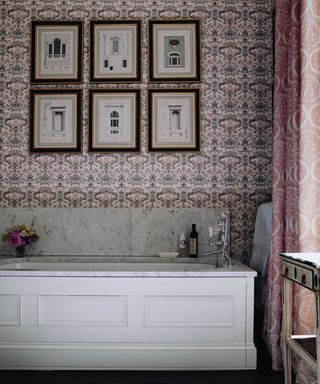 Decorative bathroom by lucy cunningham interiors with marble top bath and wall art