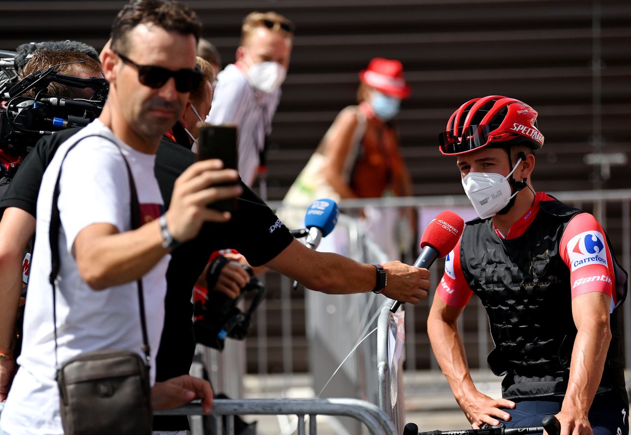 Remco Evenepoel speaks as a fan takes a selfie