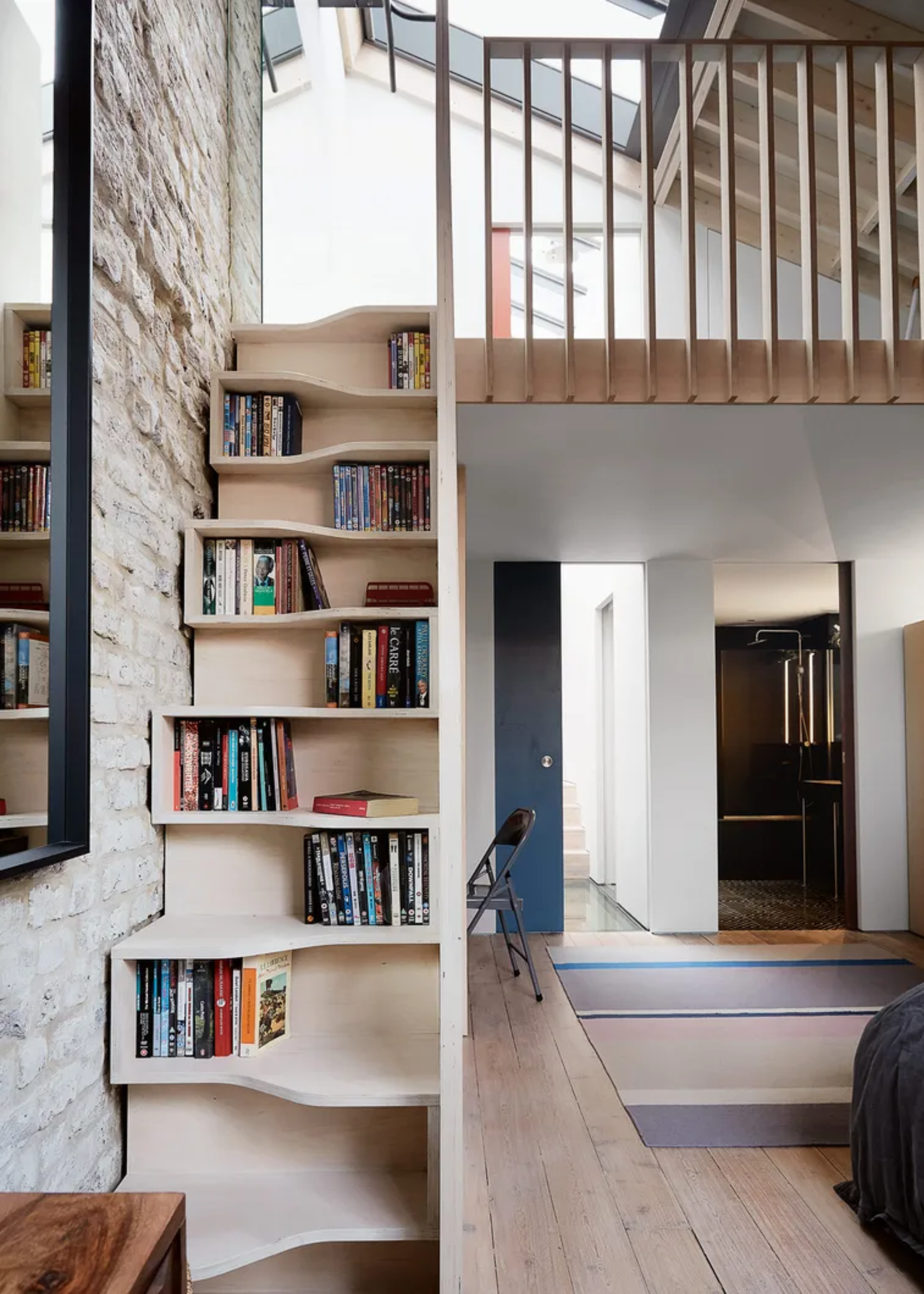 A wooden staircase with built-in book space