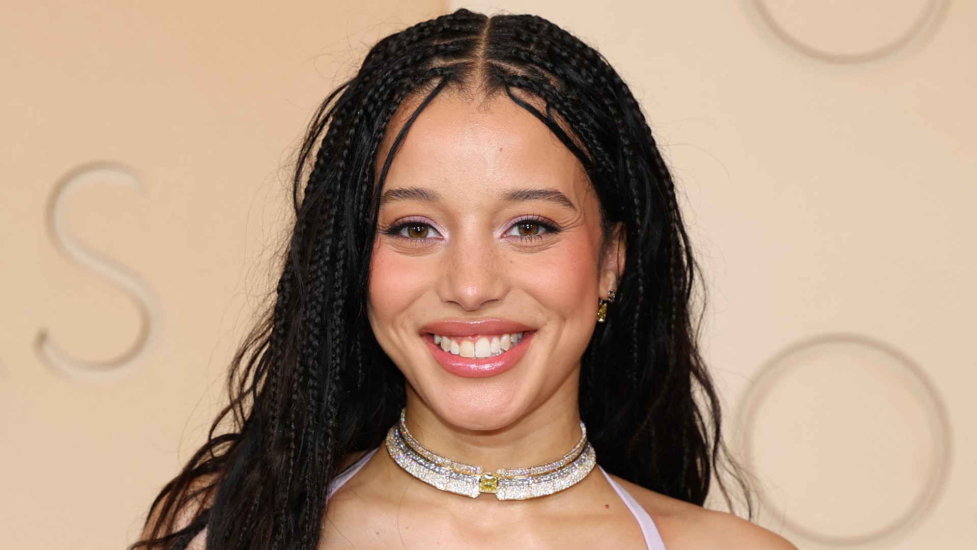 a young girl wearing long, black box braids