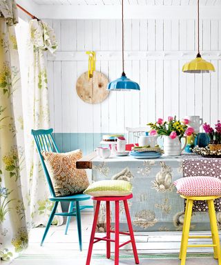 Dining room with colourful chairs and pendant lights