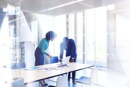 Colleagues in meeting room discussing project