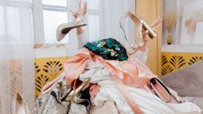 a woman buried under too many clothes - is this a big capsule wardrobe mistake?