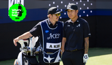 Anthony Kim chats to his caddie on the tee box