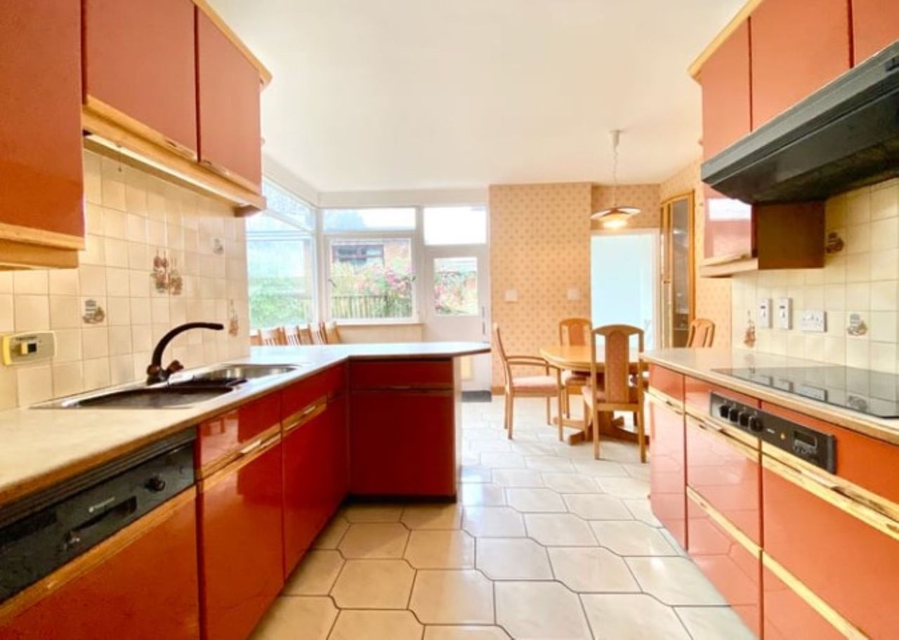 1960s style kitchen-diner with peach coloured fittings which leads out to the rear garden