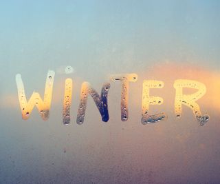 the word winter written in condensation on window