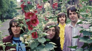 The Beatles surrounded by flowers