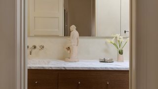 Marble bathroom countertop with cream statue