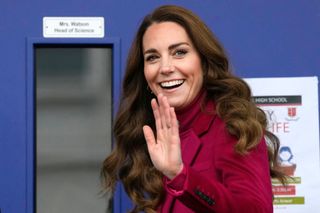 Kate Middleton curly hair - Duchess of Cambridge gestures as she arrives for a visit to Nower Hill High School in Harrow, north London on November 24, 2021, where she joined students for a science lesson studying neuroscience and the importance of early childhood development