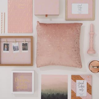 pink colour accessories with pillow and candle and picture frame