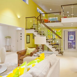 living room with yellow wall and sofaset with cushions