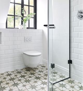 small bathroom with tiled floor and corner walk in shower