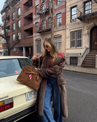 Chase Marie Wise wearing faux fur coat and suede bag in New York