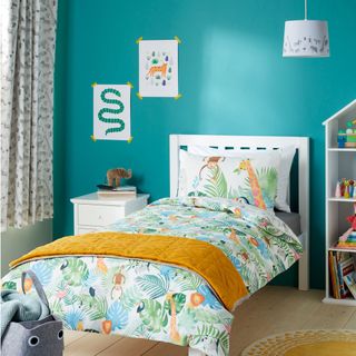 kids room with turquoise blue wall and wooden white bed