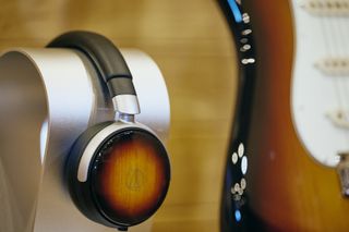 Audio-Technica ATH-WP900SE wired headphones next to a guitar