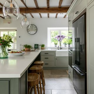 White and green country kitchen with large island