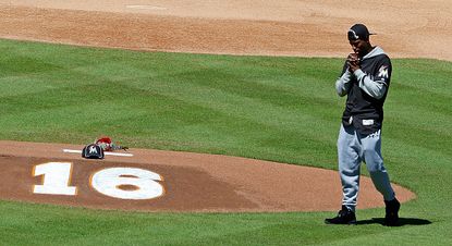 Dee Gordon stands in front of a tribute to José Fernández.