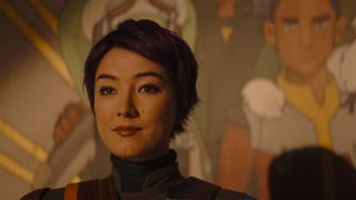 Sabine Wren stands in front of the mural from Star Wars Rebels