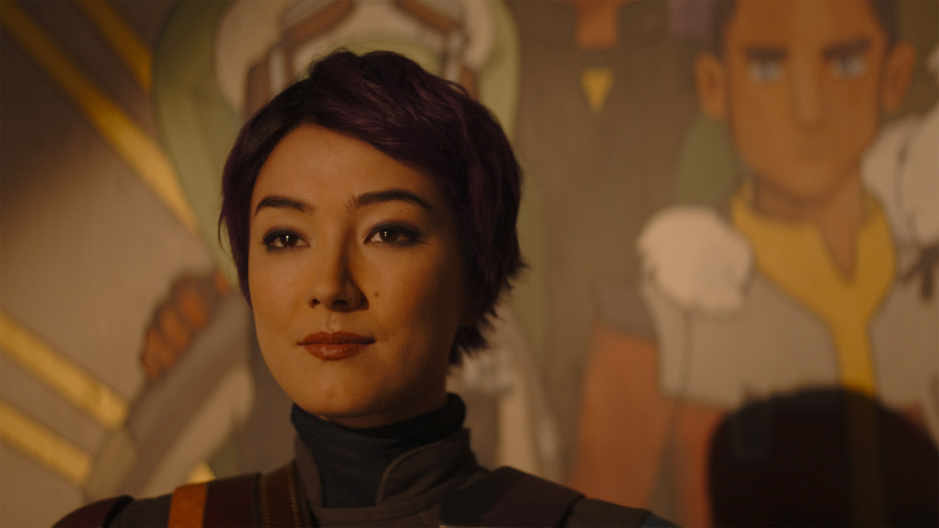 Sabine Wren stands in front of the mural from Star Wars Rebels